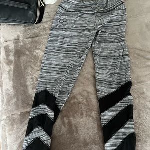 Gray and black work out pants. With mesh detail